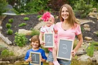 A mom and her two kids showing the birth order including a 3rd one on the way.