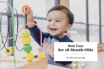 Toddler boy enjoys playing with toys