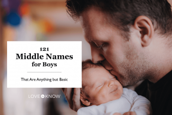 father holding a newborn baby son at home