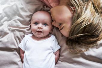 adorable baby boy bonding with his mother at home