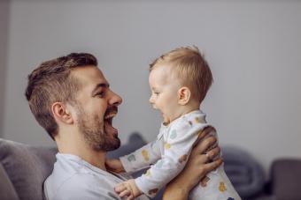 Adorable little boy playing with his father