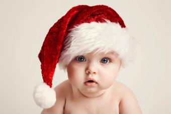 Baby Wearing Santa Hat At Home During Christmas