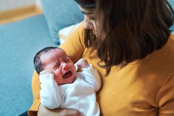 Mom cradling crying baby