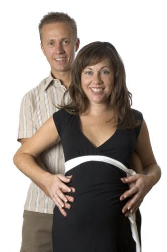 Couple both holding wife's pregnant belly