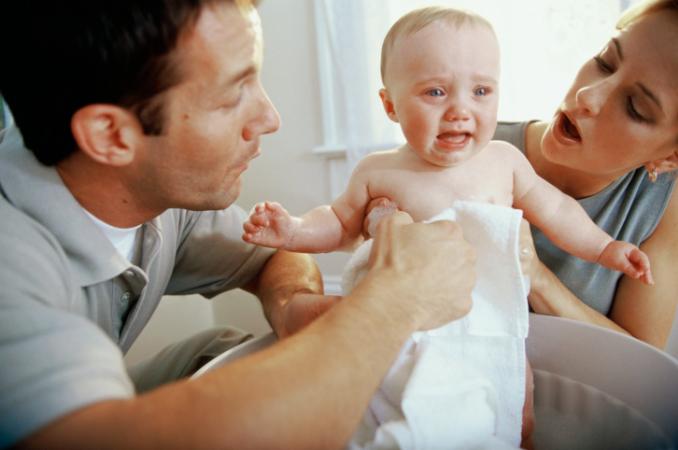 Parents giving baby a bath