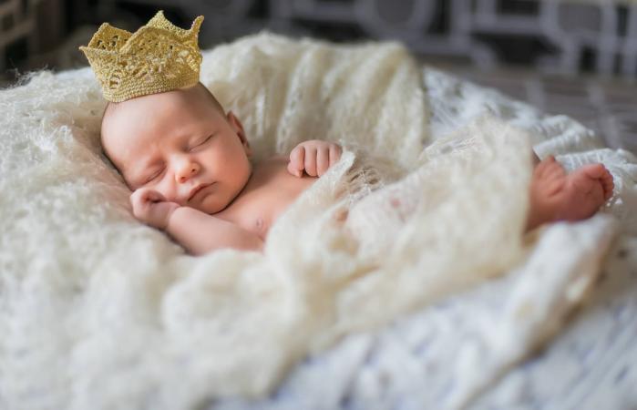 newborn baby girl wearing a crown