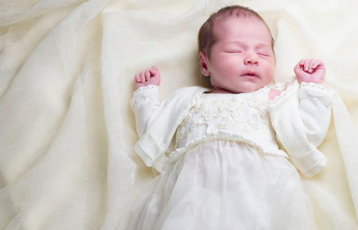 newborn baby in christening gown