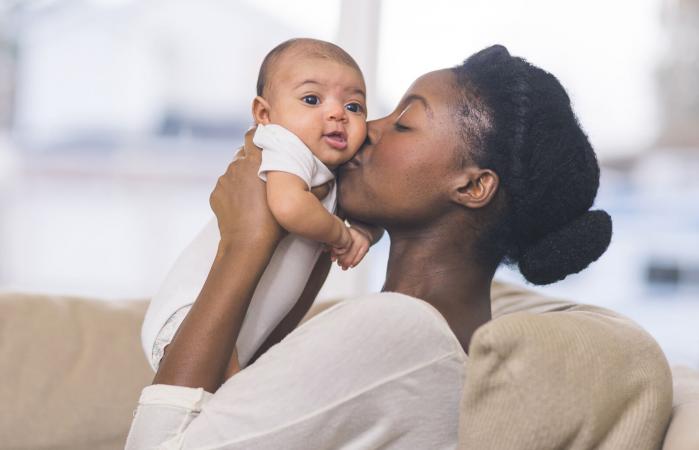 Mother kissing her baby
