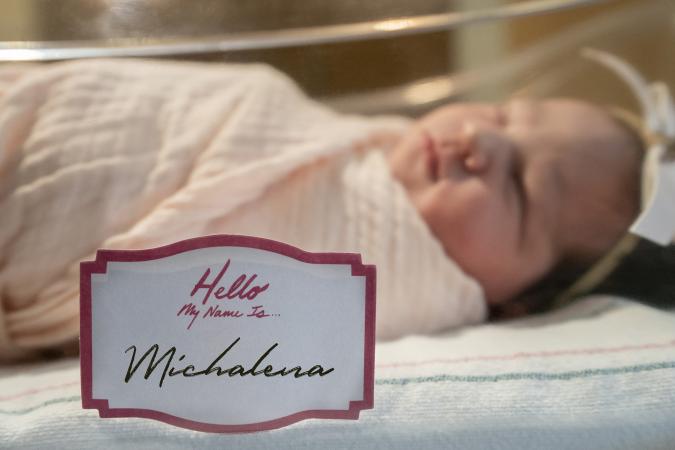 newborn baby girl with name tag