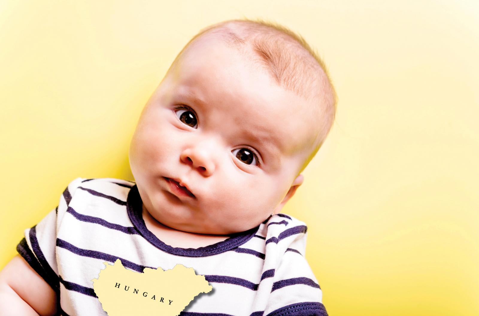 Sceptical baby in front of yellow background