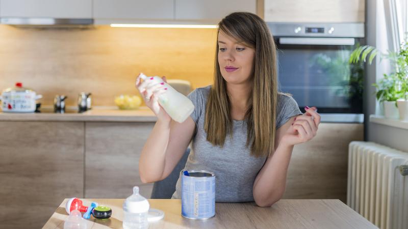 Mother making baby formula