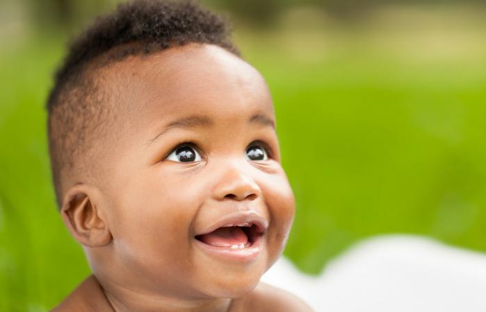 baby smiling while looking away