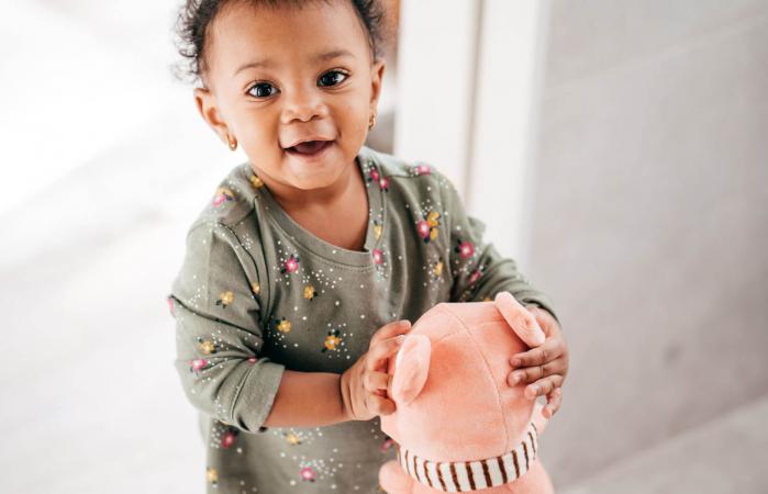 Smiling toddler with toy