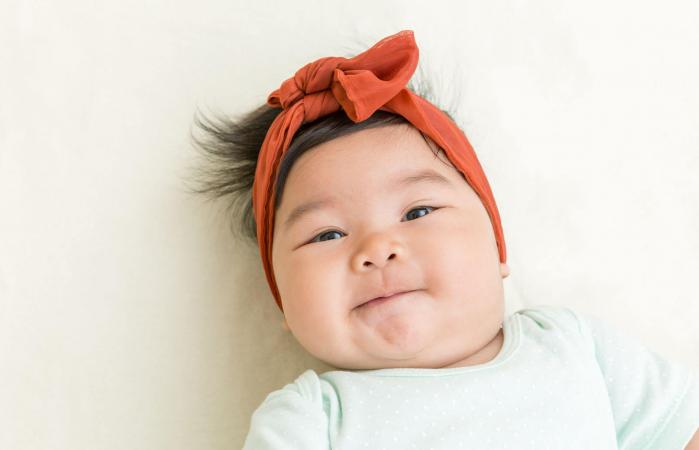 baby smiling on the bed