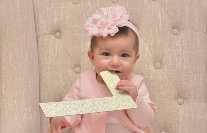 Cute Baby Girl Biting Letter L