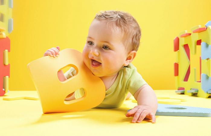 Baby boy playing with toy alphabet letters