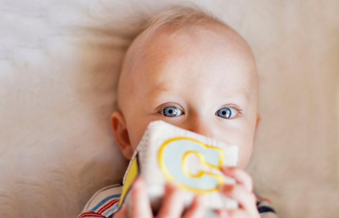 Baby boy holding plush cube
