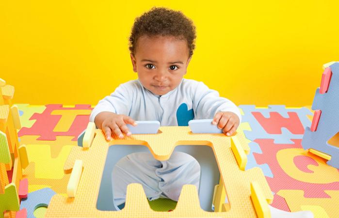 Baby boy playing with toy alphabet letters