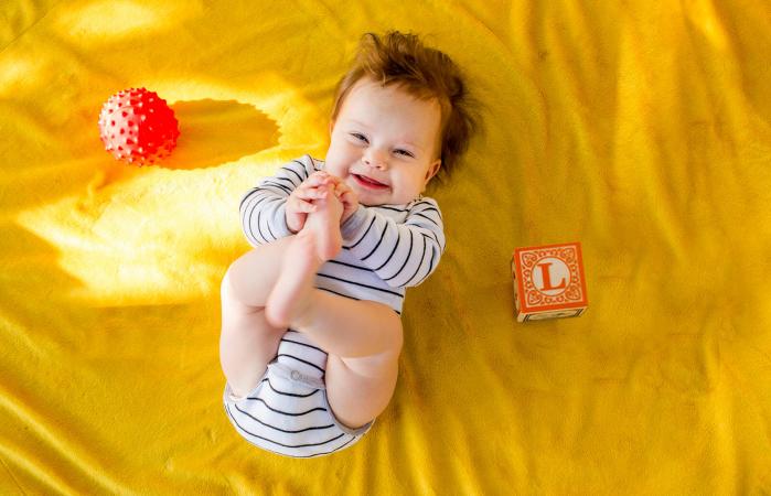 baby playing with blocks on bed