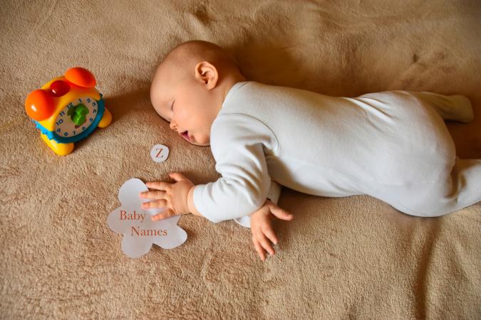 Cute Baby Girl Sleeping On Bed