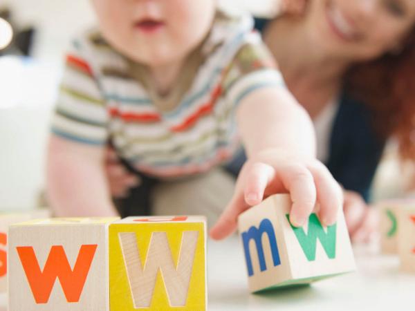 Baby boy spelling WWW with blocks