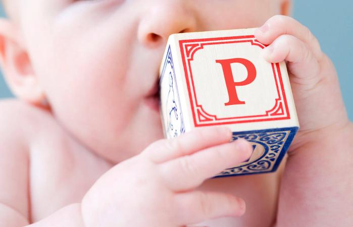 baby biting on alphabet block