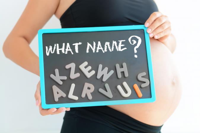 Expectant mother spelling name on her pregnant belly