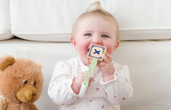 Baby playing with alphabet blocks