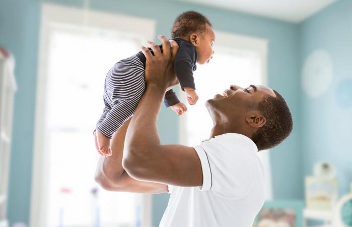 father lifting baby son