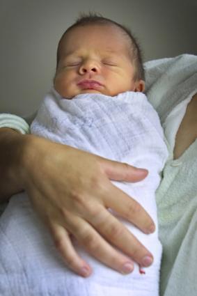 baby in swaddling blanket