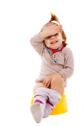 Toddler girl training to use the potty