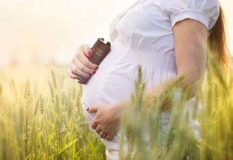 Mujer embarazada con biblia