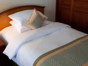 Neatly made bed turned down sheets
