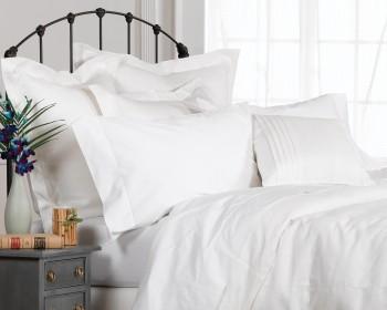white bedding and iron bed