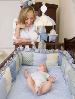 Mother watching son in crib