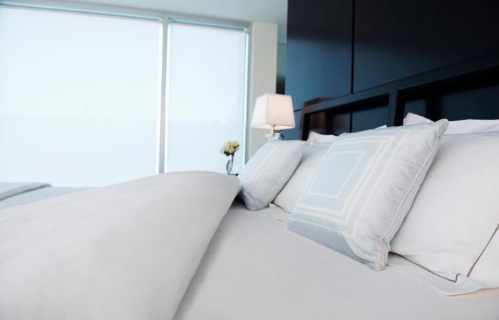 Plush white pillows on white bed