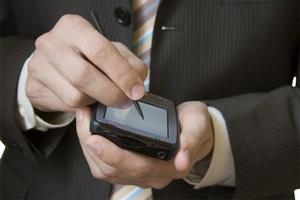 Businessman using a PDA - photo by Piotr Bizior