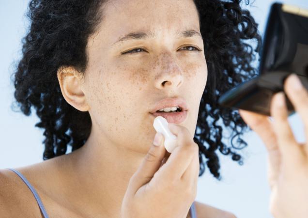 Woman applying lip balm