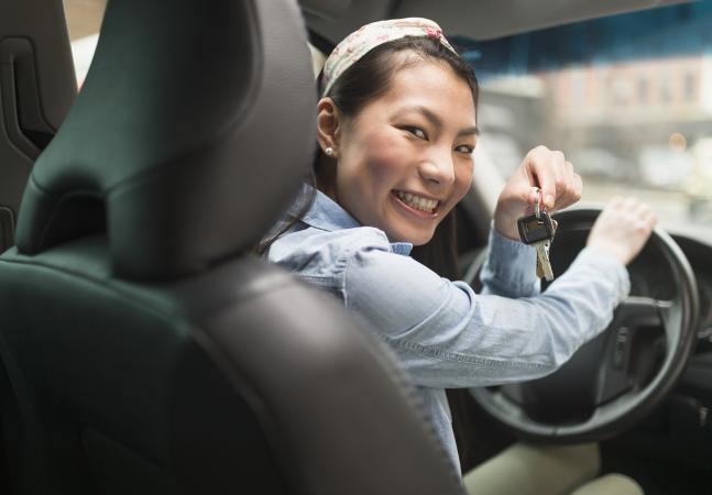 teenage girl holding keys to car