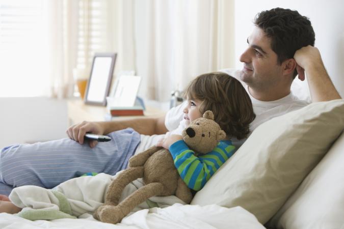 father and son watching television