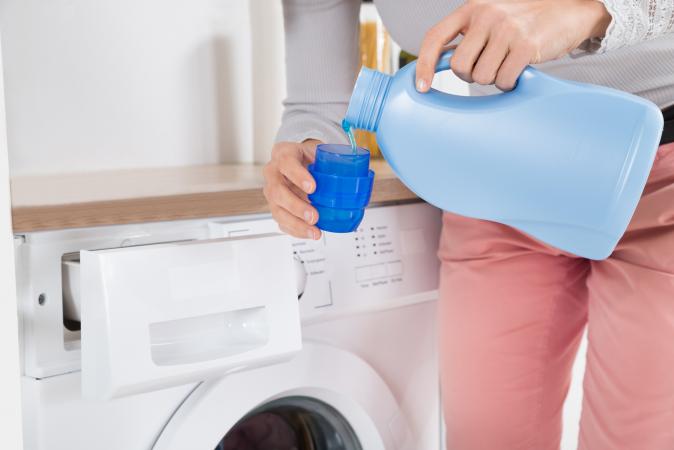 Pouring Detergent In Bottle Cap