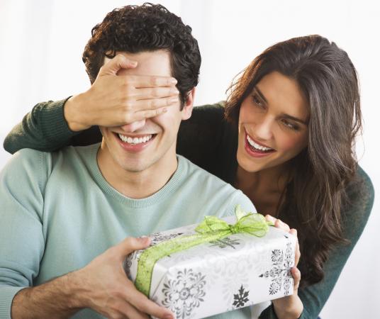 woman giving boyfriend a gift