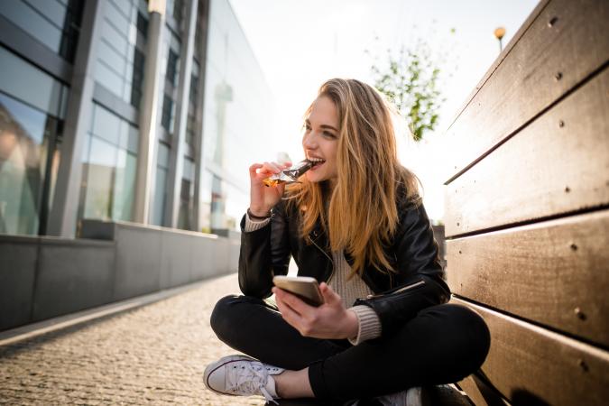 teenager eating candy bar