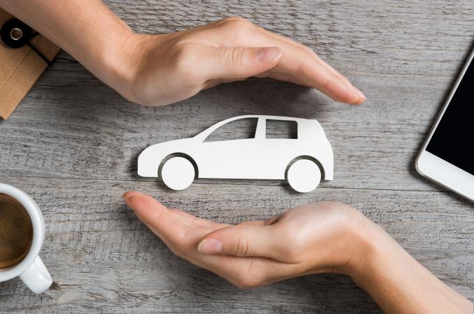 Hands protecting icon of car