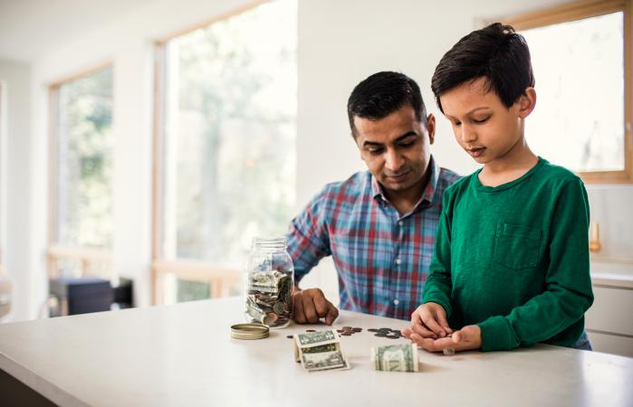 Father and son counting money at home
