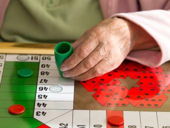 Woman playing Parcheesi boardgame