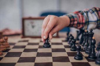 Boy making a move in chess match