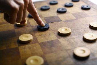 Hand on checkers board game