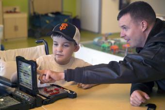 U.S. Navy Capt. plays the board game Battleship with a kid