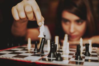 Young woman playing ches